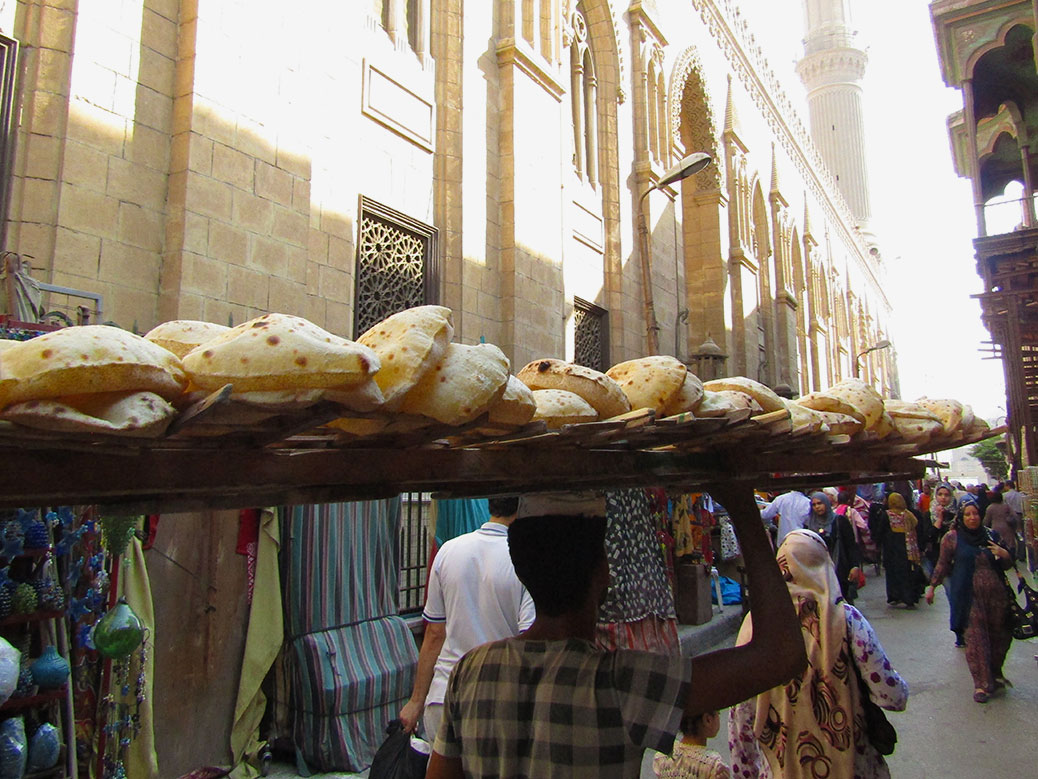 A baladi bread seller appeared behind us with a balancing act on his head!