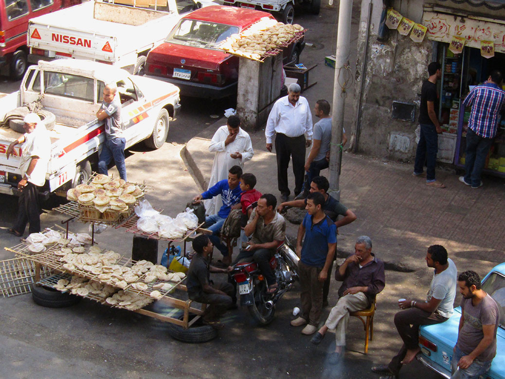 The restaurant is located in a busy area. I took this picture from the second floor looking down at the street where these men were enjoying the national pastime of people watching.