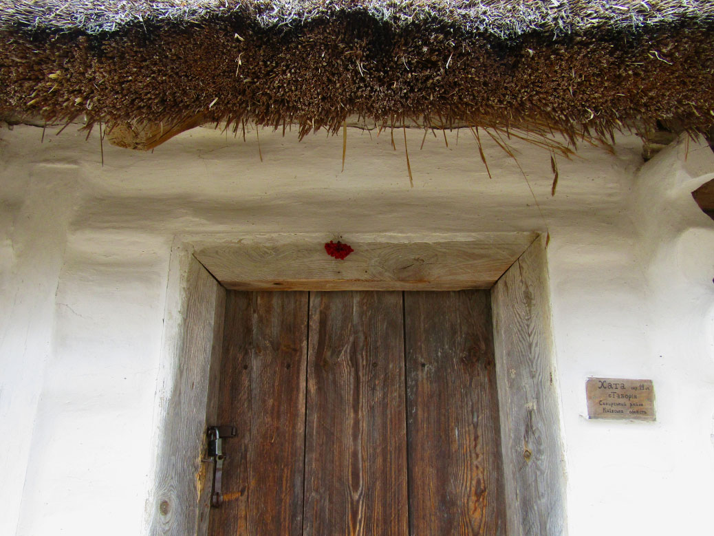 This 19th century home has kalyna hung over the doorway. Kalyna is a red berry similar to cranberries and is a national symbol of Ukraine.