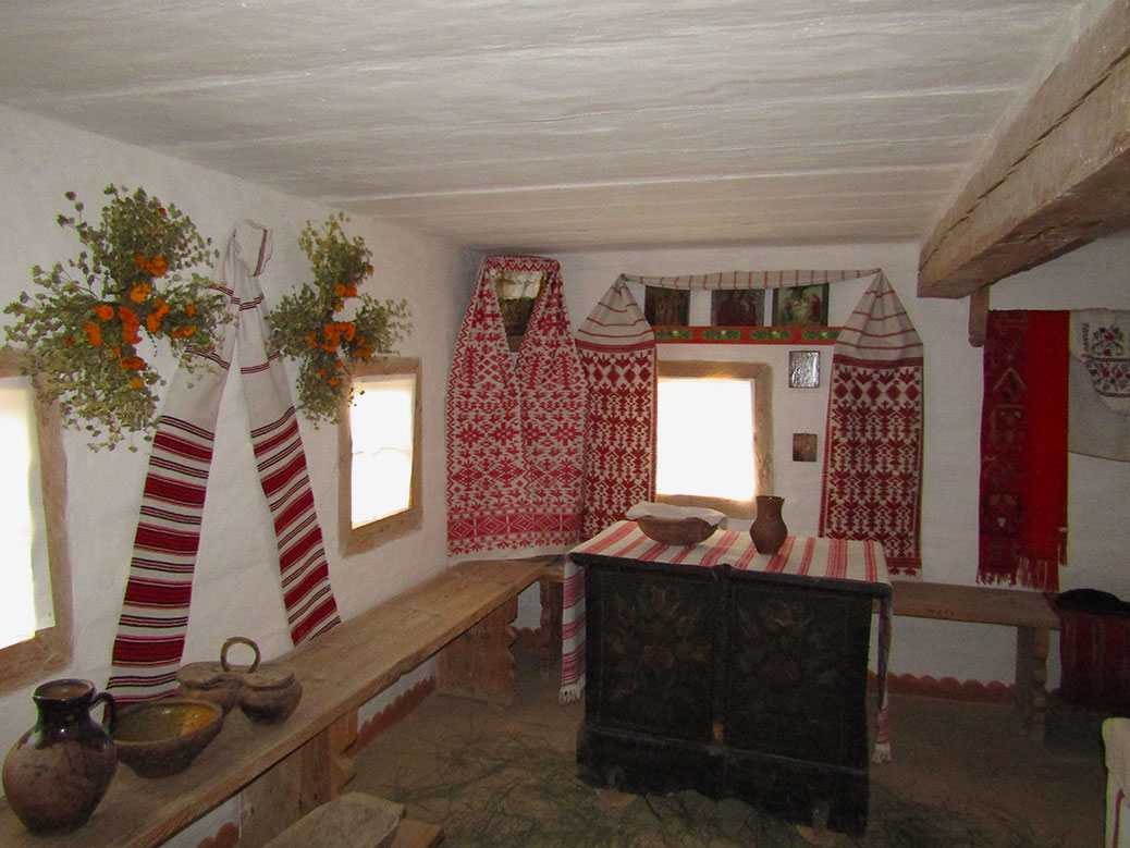 We were able to see into the interior of some of the homes. This is the kitchen and main living area. It has the traditional red embroidered linens and flowers and herbs drying on the walls.