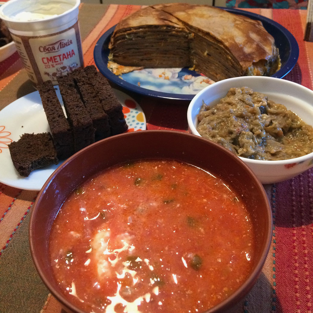 Red beet borscht soup with an eggplant dip and a layered crepe dish.