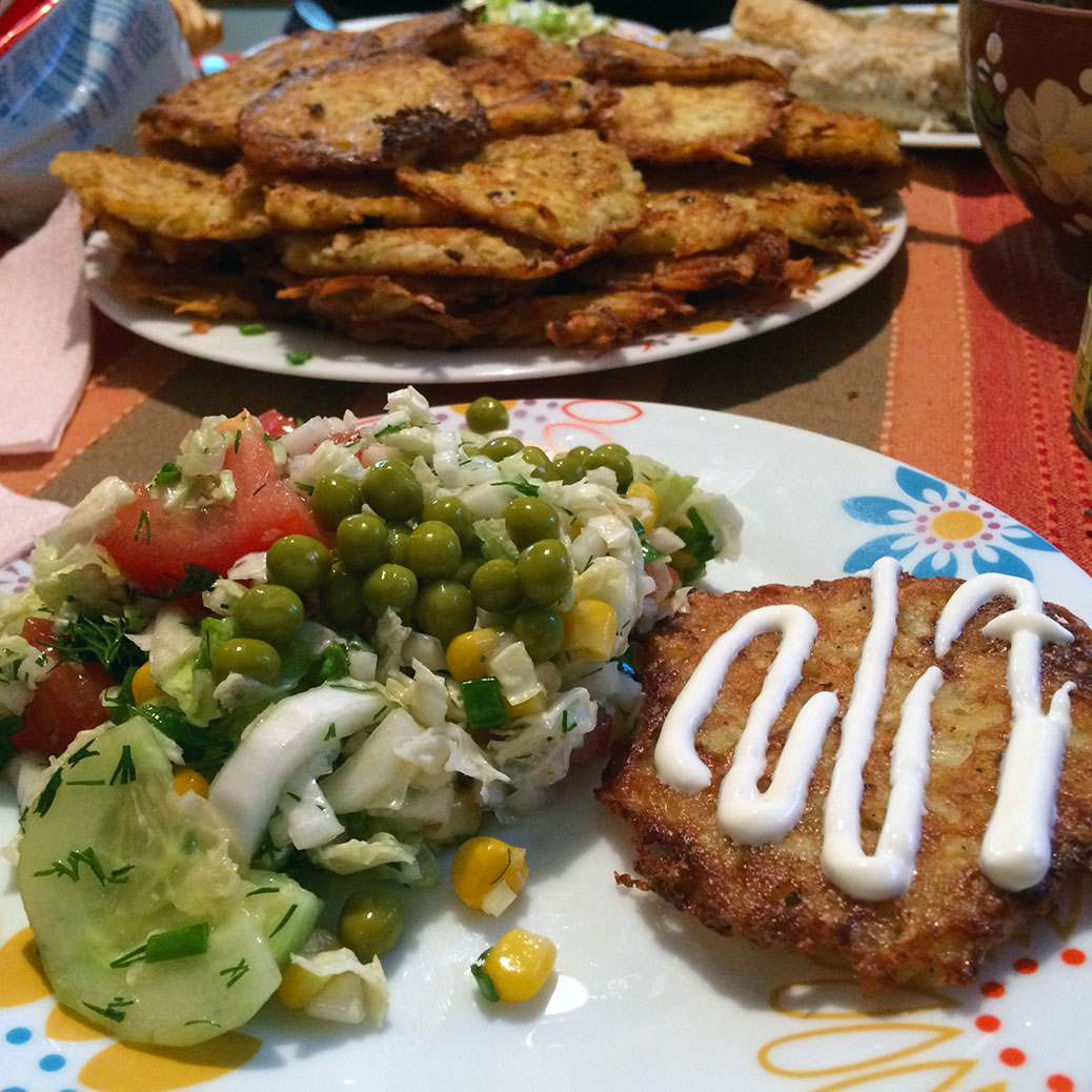 Salad and potato pancakes topped with sour cream, of course!