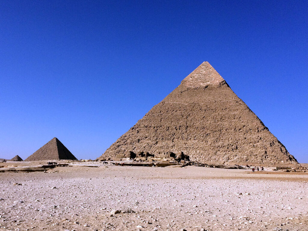 Khafre's Pyramid and Menkaure's Pyramid. In the distance, a smaller pyramid belonging to one of Khufu's wives can be seen.