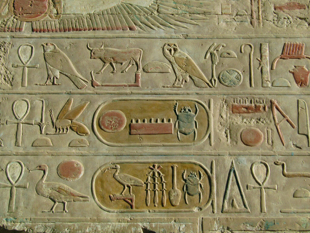 Enclosed hieroglyphics in the Temple of Hatshepsut. Known as cartouche, they indicate a name and the beetle (scarab) usually denotes the name of a pharaoh. The top shows the name of Pharaoh Thutmose III, nephew/stepson and heir to Hatshepsut.