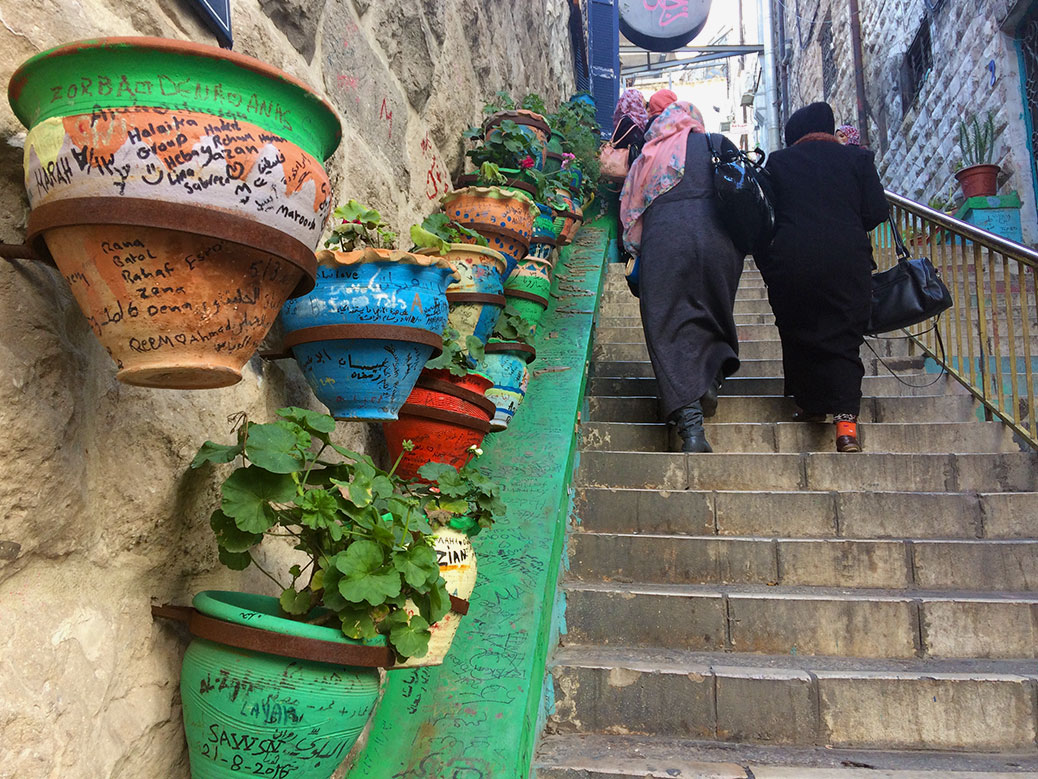 A staircase off Prince Muhammad Street features colorful flowerpots with graffiti left by visitors from around the world.